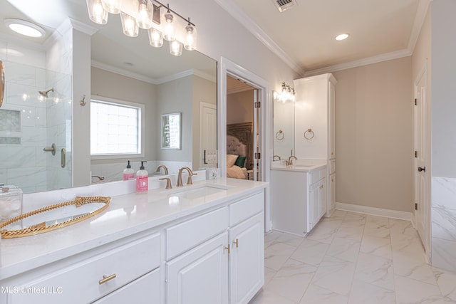 bathroom featuring vanity, a shower with shower door, and ornamental molding