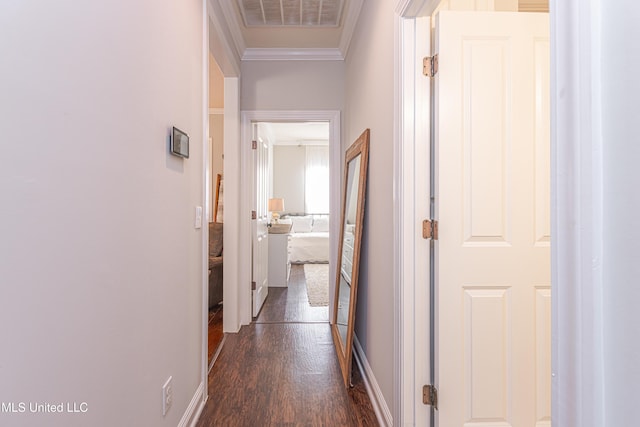 hallway with dark hardwood / wood-style flooring and ornamental molding