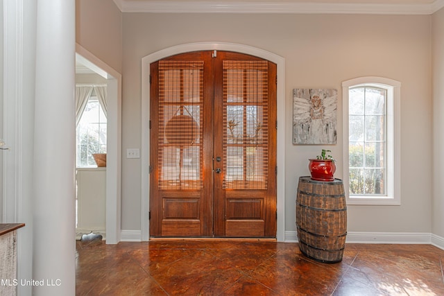 foyer entrance featuring french doors and crown molding