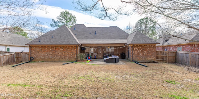 back of property featuring a lawn and a patio