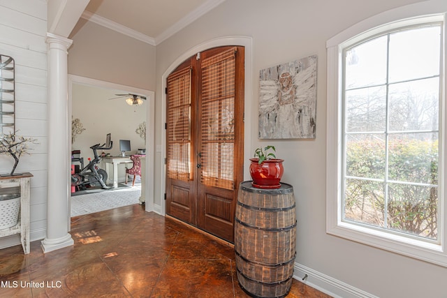 foyer with ornamental molding, french doors, ceiling fan, and ornate columns