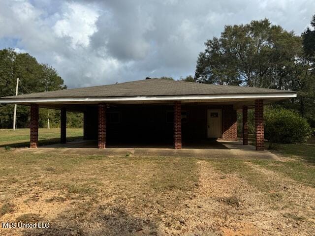 exterior space featuring a lawn and a carport