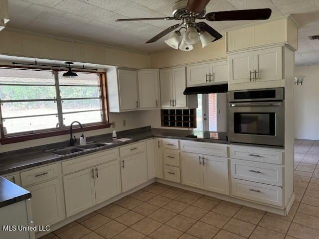 kitchen with black electric cooktop, oven, plenty of natural light, and sink