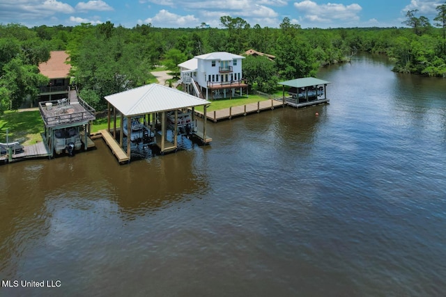 6085 Shawnee St, Kiln, MS 39556 - dock featuring boat lift, a wooded view, and a water view