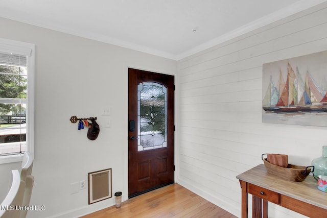 6085 Shawnee St, Kiln, MS 39556 - foyer with healthy amount of natural light, light wood-type flooring, wooden walls, and ornamental molding