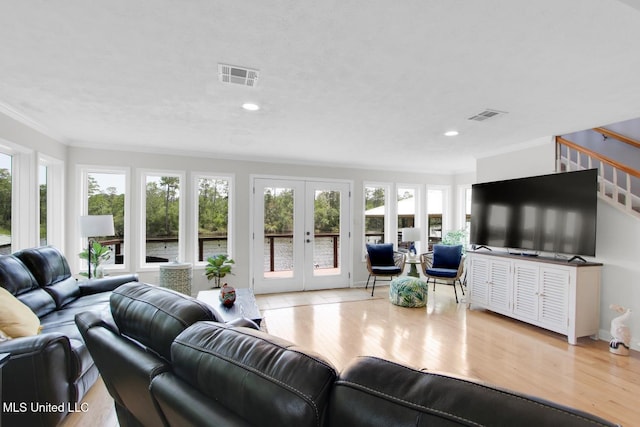 6085 Shawnee St, Kiln, MS 39556 - living area featuring ornamental molding, french doors, wood finished floors, stairway, and recessed lighting