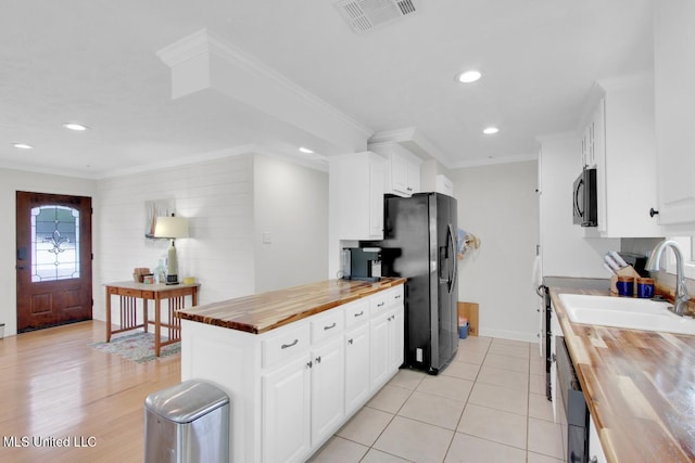 6085 Shawnee St, Kiln, MS 39556 - kitchen featuring wood counters, fridge with ice dispenser, a sink, white cabinets, and recessed lighting