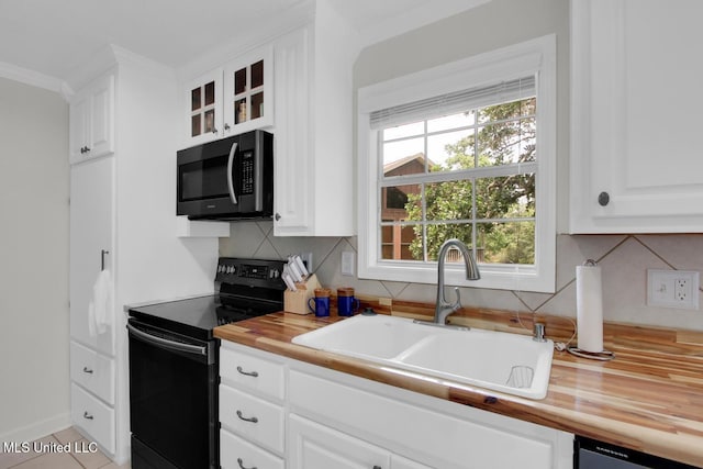 6085 Shawnee St, Kiln, MS 39556 - kitchen with black range with electric stovetop, a sink, butcher block countertops, tasteful backsplash, and plenty of natural light