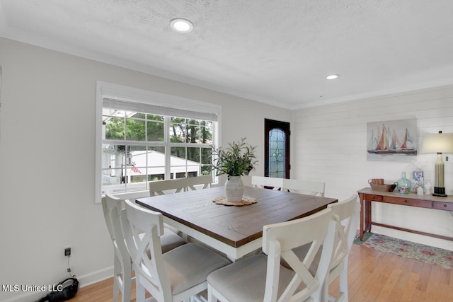 6085 Shawnee St, Kiln, MS 39556 - dining space with light wood-type flooring, recessed lighting, wooden walls, baseboards, and a textured ceiling