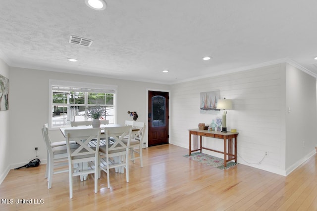 6085 Shawnee St, Kiln, MS 39556 - dining area featuring light wood-type flooring, recessed lighting, ornamental molding, baseboards, and a textured ceiling