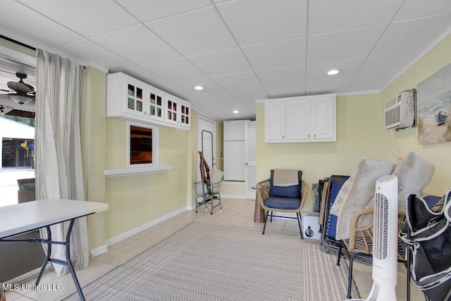6085 Shawnee St, Kiln, MS 39556 - sitting room with light tile patterned floors, recessed lighting, baseboards, an AC wall unit, and a paneled ceiling