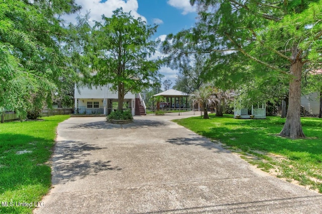 6085 Shawnee St, Kiln, MS 39556 - view of front of property featuring concrete driveway, stairs, and a gazebo