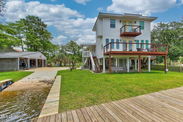 6085 Shawnee St, Kiln, MS 39556 - rear view of property with a balcony, driveway, a wooden deck, and stairs