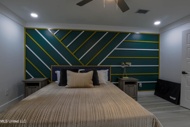 bedroom featuring baseboards, wood finished floors, visible vents, and recessed lighting