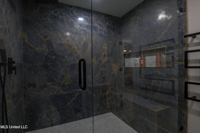 full bath featuring a marble finish shower