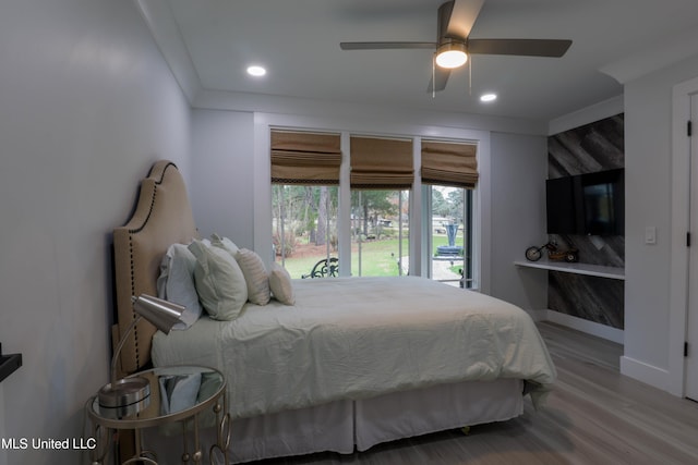 bedroom with a ceiling fan, recessed lighting, baseboards, and wood finished floors