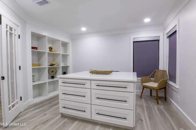 walk in closet with light wood finished floors and visible vents