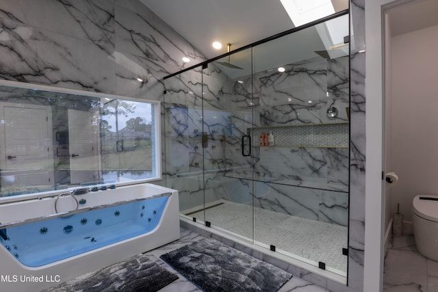 bathroom with a skylight, marble finish floor, a marble finish shower, and a whirlpool tub