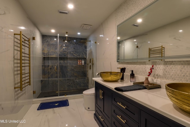 full bath with a sink, visible vents, tile walls, double vanity, and a stall shower