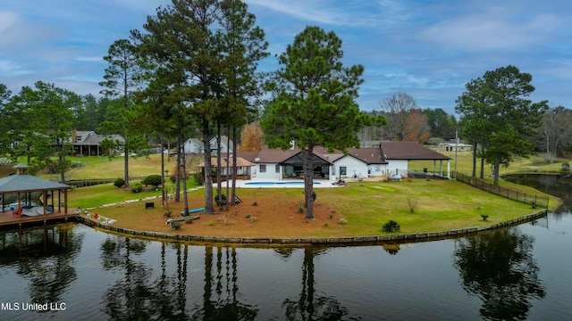 exterior space with a fenced backyard, a water view, a gazebo, a yard, and an outdoor pool