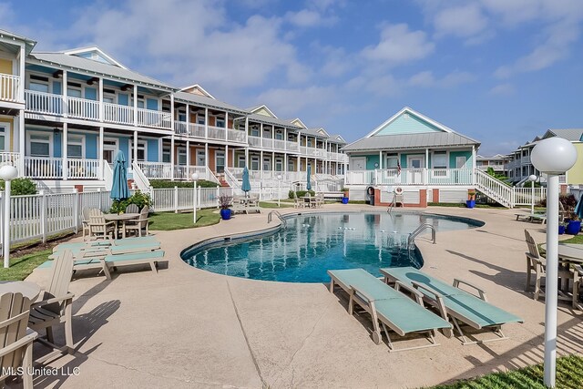 1515 E Beach Blvd Unit 105, Pass Christian, MS 39571 - exterior space with stairs, a ceiling fan, fence, and a residential view