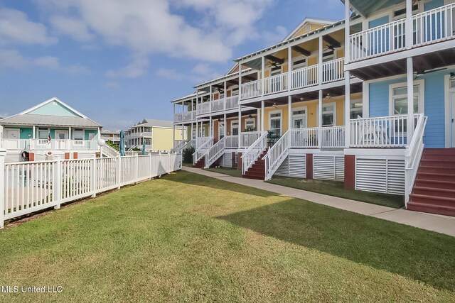 1515 E Beach Blvd Unit 105, Pass Christian, MS 39571 - back of house featuring a residential view, fence, a lawn, and stairs