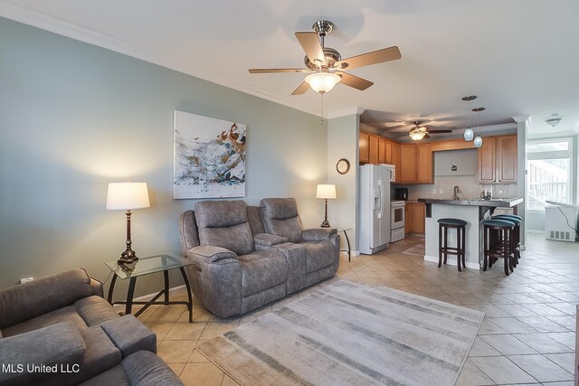 1515 E Beach Blvd Unit 105, Pass Christian, MS 39571 - living area featuring ceiling fan, crown molding, baseboards, and light tile patterned floors