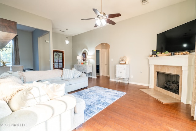 living room with a fireplace, hardwood / wood-style flooring, and ceiling fan