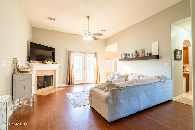 living room featuring ceiling fan and dark hardwood / wood-style flooring