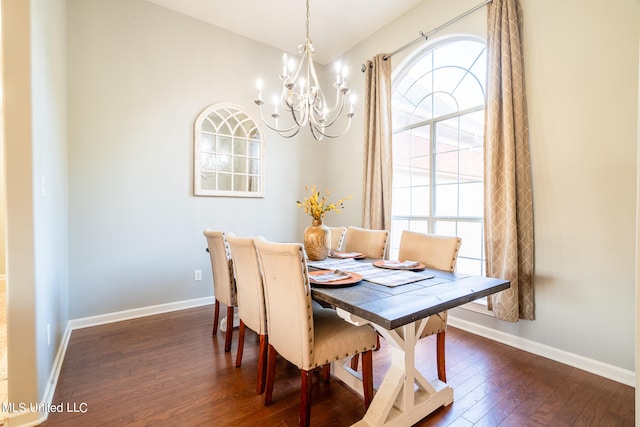 dining area with dark wood-type flooring and a chandelier