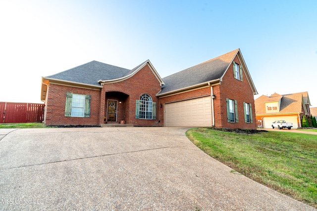 view of front of home with a front yard and a garage