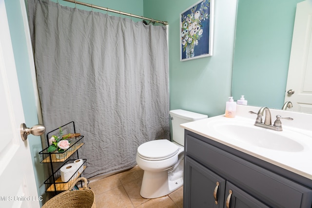 bathroom featuring vanity, toilet, tile patterned floors, and curtained shower