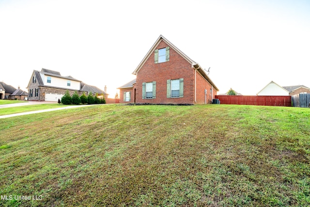 view of property exterior with a yard and central AC unit