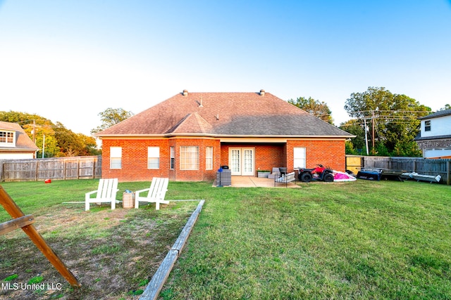 back of house featuring a yard and a patio area