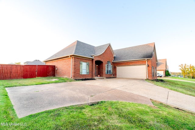 view of front of house with a front yard and a garage