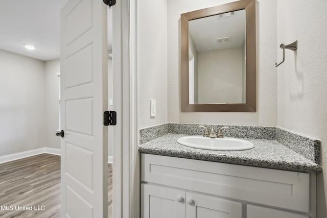 bathroom featuring vanity and wood-type flooring