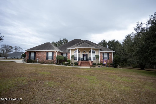 4 Mitchell Cv, Carriere, MS 39426 - view of front facade featuring a front yard and brick siding
