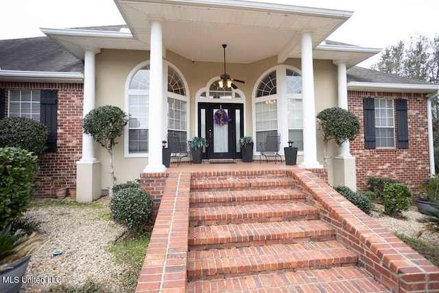 4 Mitchell Cv, Carriere, MS 39426 - view of exterior entry with stucco siding, brick siding, a porch, and a shingled roof