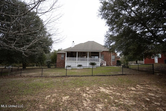4 Mitchell Cv, Carriere, MS 39426 - rear view of house featuring a chimney, a sunroom, and brick siding
