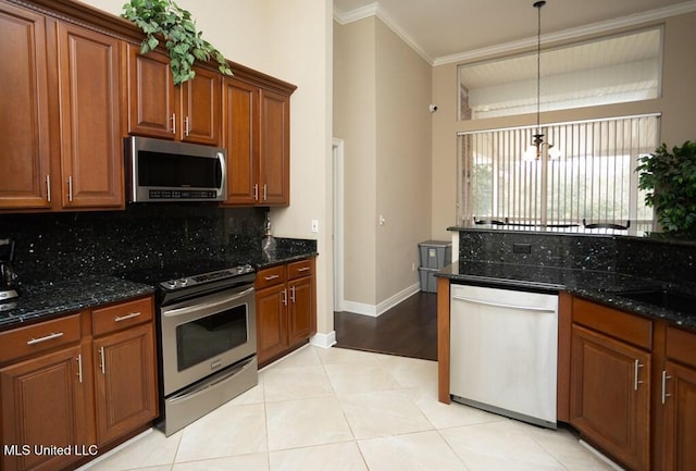 4 Mitchell Cv, Carriere, MS 39426 - kitchen with stainless steel appliances, backsplash, crown molding, brown cabinets, and dark stone counters