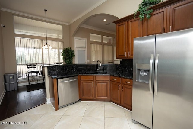 4 Mitchell Cv, Carriere, MS 39426 - kitchen with stainless steel appliances, a sink, brown cabinets, tasteful backsplash, and ornamental molding