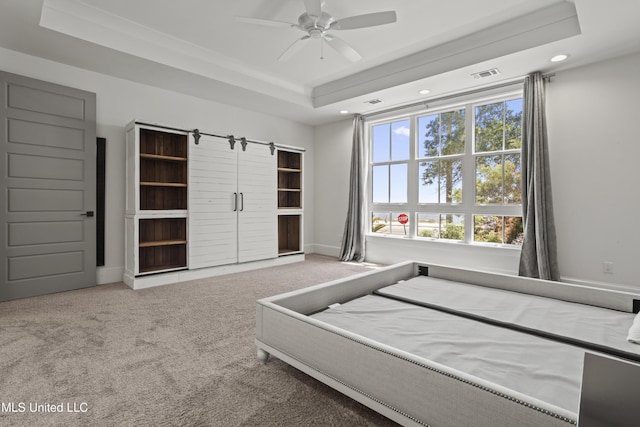 bedroom with a tray ceiling, carpet flooring, recessed lighting, baseboards, and a ceiling fan