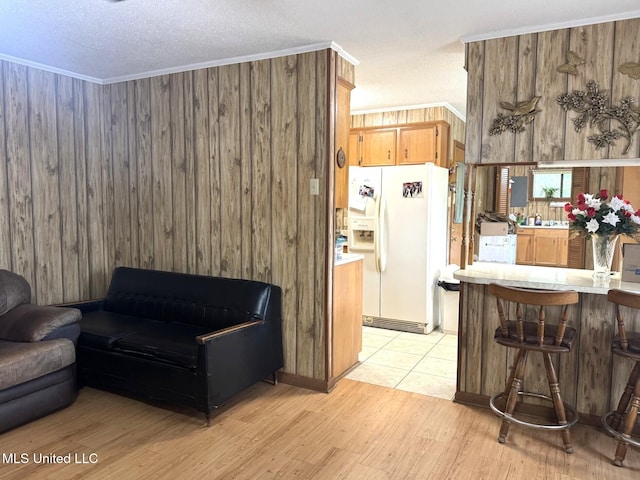 25 Cloverdale Rd, Natchez, MS 39120 - living area with light wood finished floors, a textured ceiling, ornamental molding, and wooden walls