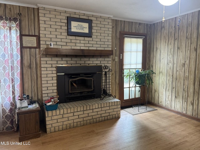 25 Cloverdale Rd, Natchez, MS 39120 - unfurnished living room with crown molding, a fireplace, wood finished floors, wood walls, and baseboards