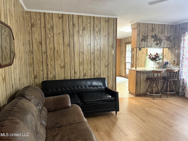 25 Cloverdale Rd, Natchez, MS 39120 - living room with wood walls, light wood finished floors, a textured ceiling, and crown molding