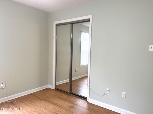 25 Cloverdale Rd, Natchez, MS 39120 - unfurnished bedroom with a closet, baseboards, and light wood-style flooring