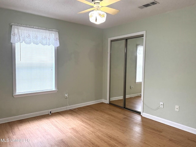 25 Cloverdale Rd, Natchez, MS 39120 - unfurnished bedroom featuring baseboards, wood finished floors, a closet, and a ceiling fan