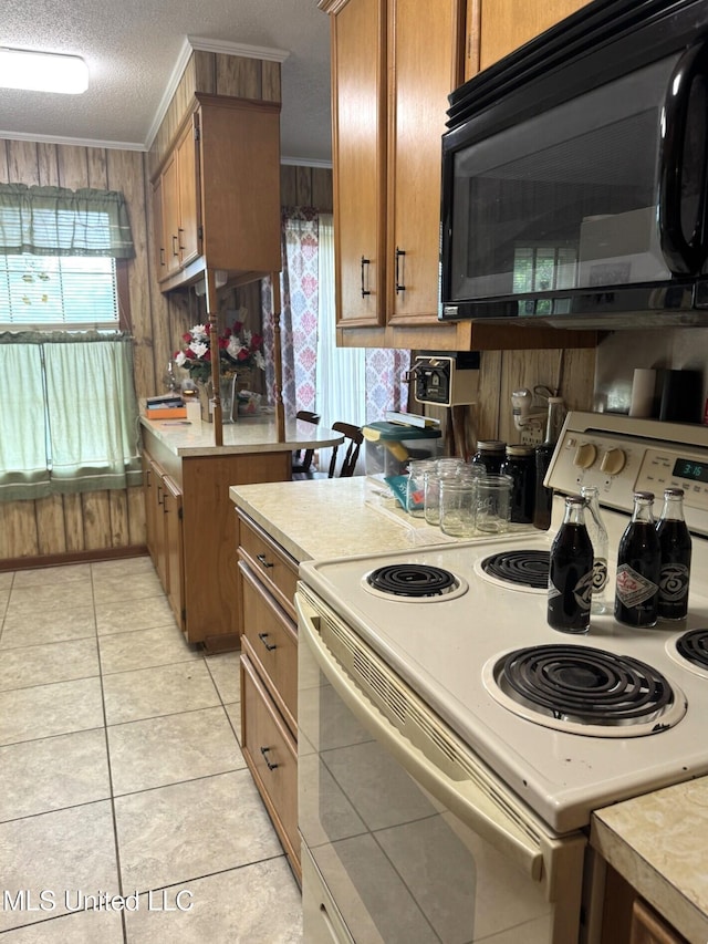 25 Cloverdale Rd, Natchez, MS 39120 - kitchen featuring white electric range oven, black microwave, light countertops, brown cabinets, and a textured ceiling