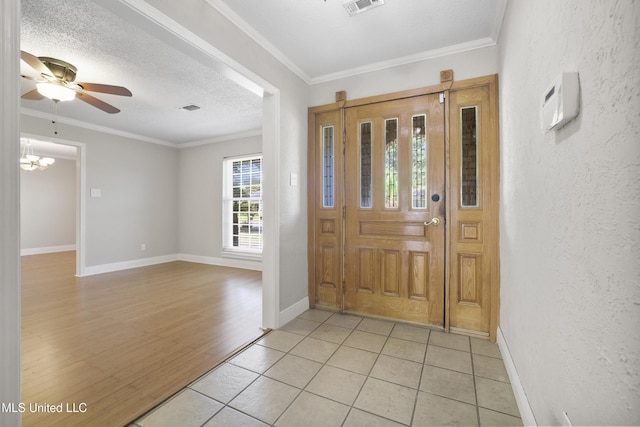 429 Linda Dr, Biloxi, MS 39531 - foyer with ornamental molding, a ceiling fan, light tile patterned floors, a chandelier, and a textured wall