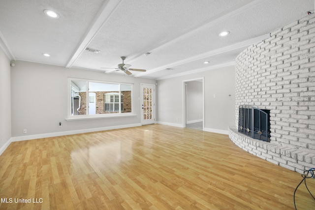 429 Linda Dr, Biloxi, MS 39531 - unfurnished living room featuring a textured ceiling, ceiling fan, light wood-style floors, a brick fireplace, and recessed lighting